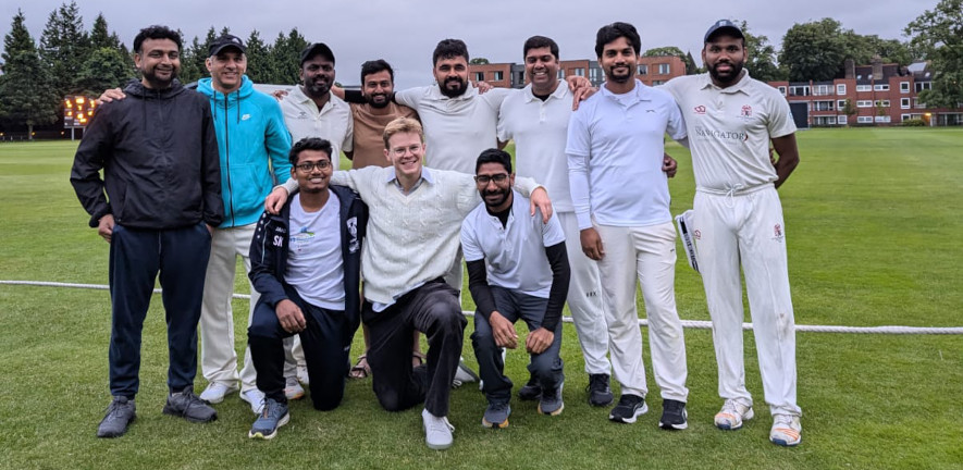 The members of the chemistry cricket team standing in two rows smiling at camera